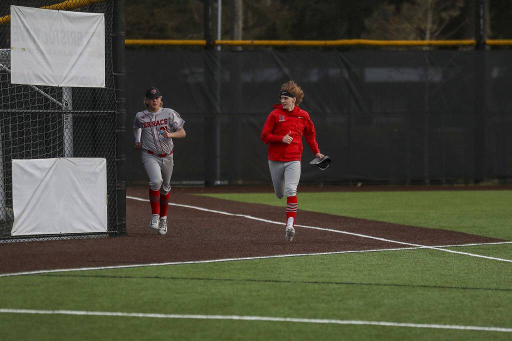 Mountlake Terrace players warm up during a baseball game between Edmonds-Woodway and Mountlake Terrace at Edmonds-Woodway High School in Edmonds, Washington on Thursday, April 13, 2023. The Warriors won, 5-1. (Annie Barker / The Herald)