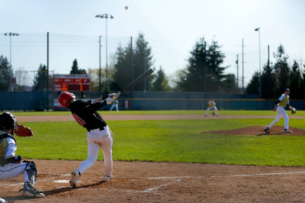 A Snohomish batter bloops a hit into the outfield during a matchup against Arlington on Friday, April 14, 2023, at Earl Torgeson Field in Snohomish, Washington. (Ryan Berry / The Herald)
