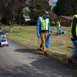 Volunteers walk through the Marysville Cemetery and pick up trash on Tuesday, April 18, 2023 in Marysville, Washington. (Olivia Vanni / The Herald)