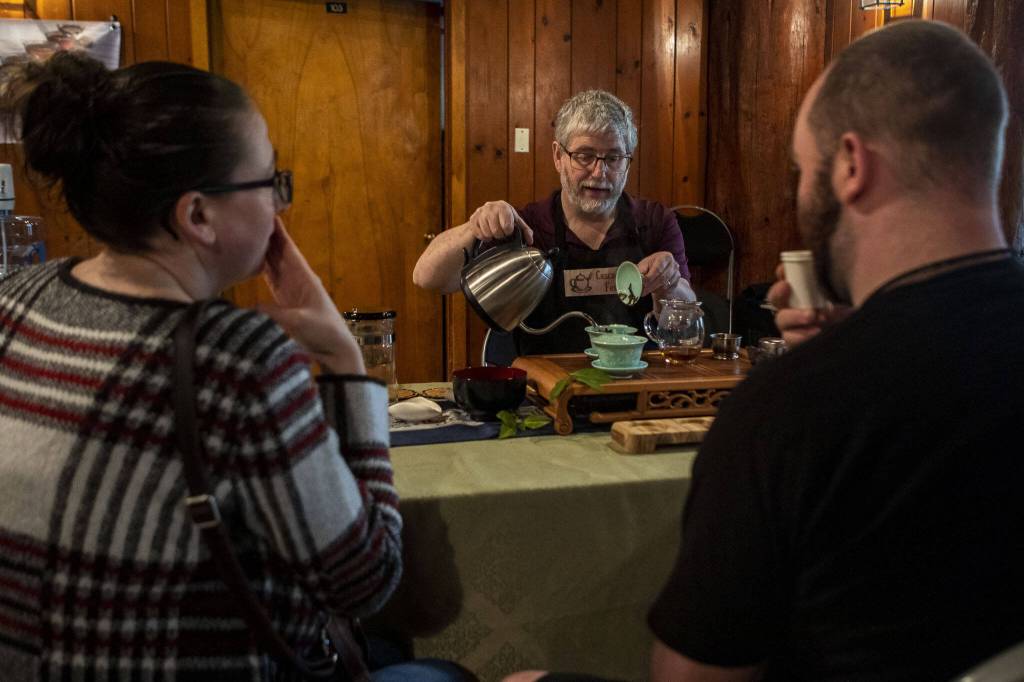 Charles Dawson pours a Taiwanese black tea during the Cascadia Tea spring festival at Floral Hall in Everett, Washington on Saturday, April 15, 2023. (Annie Barker / The Herald)