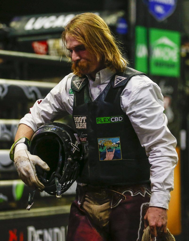 Aaron Williams reacts after falling off a bull during Unleash The Beast at Angel of the Winds Arena in Everett, Washington on Thursday, April 20, 2023. (Annie Barker / The Herald)