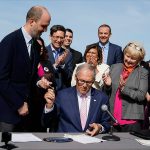Washington Gov. Jay Inslee hands a pen to Rep. Drew Hansen, D-Bainbridge Island, left, after signing House Bill 1469, which shields abortion and gender-affirming care patients and providers from prosecution by out-of-state authorities and prevents cooperation with investigations, Thursday, April 27, 2023, at the University of Washington's Hans Rosling Center for Population Health in Seattle. (AP Photo/Lindsey Wasson)