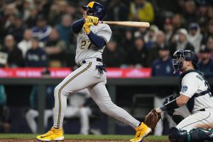 Milwaukee Brewers' Willy Adames follows through on a solo home run against the Seattle Mariners as catcher Cal Raleigh looks on during the sixth inning of a baseball game Tuesday, April 18, 2023, in Seattle. (AP Photo/Lindsey Wasson)