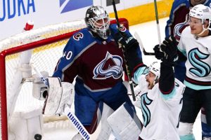 Seattle Kraken right wing Oliver Bjorkstrand (22) celebrates a goal by right wing Eeli Tolvanen (20) on Colorado Avalanche goaltender Alexandar George (40) during the first period in Game 1 of a first-round NHL hockey playoff series Tuesday, April 18, 2023, in Denver. (AP Photo/Jack Dempsey)
