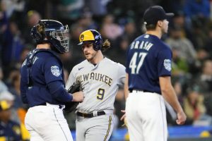 Milwaukee Brewers' Brian Anderson scores on a single by Brice Turang, next to Seattle Mariners catcher Tom Murphy and relief pitcher Matt Brash during the seventh inning of a baseball game Wednesday, April 19, 2023, in Seattle. (AP Photo/Lindsey Wasson)