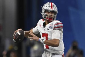 FILE -  Ohio State quarterback C.J. Stroud (7) passes against Georgia during the first half of the Peach Bowl NCAA college football semifinal playoff game, Saturday, Dec. 31, 2022, in Atlanta. The Panthers have traded up to acquire the No. 1 overall pick in the draft from the Chicago Bears in exchange for Carolina's No. 9 and No. 61 overall picks in 2023, a first-round pick in 2024, a second-round pick in 2025 and star wide receiver D.J. Moore, two people familiar with the deal said Friday, March 10, 2023, The people spoke to The Associated Press on condition of anonymity because the trade had not been announced. The move allows the Panthers to acquire a potential franchise quarterback, although it remains unclear which player the team prefers. (AP Photo/Danny Karnik, File)