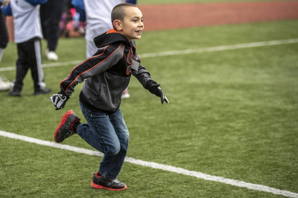 Max runs the bases during a game of YMCAs Miracle League Baseball at Monroe Rotary Field in Monroe, Washington on Saturday, April 22, 2023. The program is designed to allow people with diverse abilities to play baseball. (Annie Barker / The Herald)