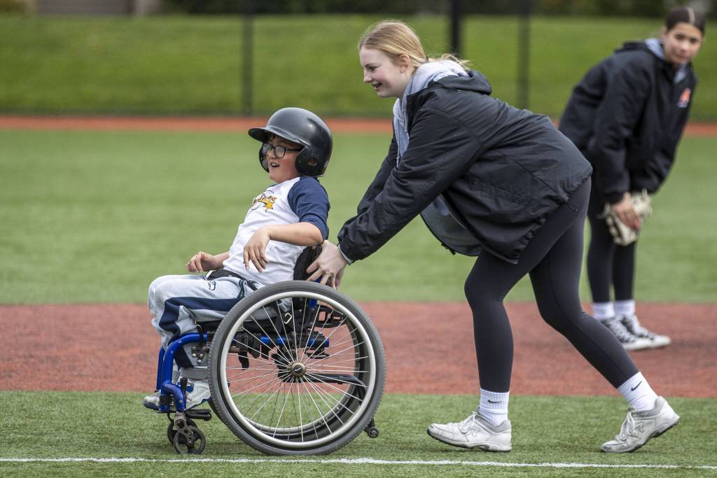 Edgerrin Burkett, 11, rounds the bases during a game of YMCAs Miracle League Baseball at Monroe Rotary Field in Monroe, Washington on Saturday, April 22, 2023. The program is designed to allow people with diverse abilities to play baseball. (Annie Barker / The Herald)