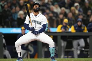 Seattle Mariners' Teoscar Hernandez reacts after striking out looking to end the 10th inning of the team's baseball game against the Milwaukee Brewers, Tuesday, April 18, 2023, in Seattle. (AP Photo/Lindsey Wasson)