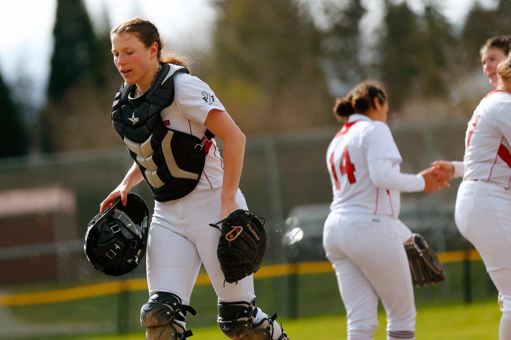 Mountlake Terrace catcher Cameron Dunn heads back behind the plate after a meeting at the mound during a game against Archbishop Murphy on Tuesday, April 18, 2023, at her team’s home field in Mountlake Terrace, Washington. (Ryan Berry / The Herald)