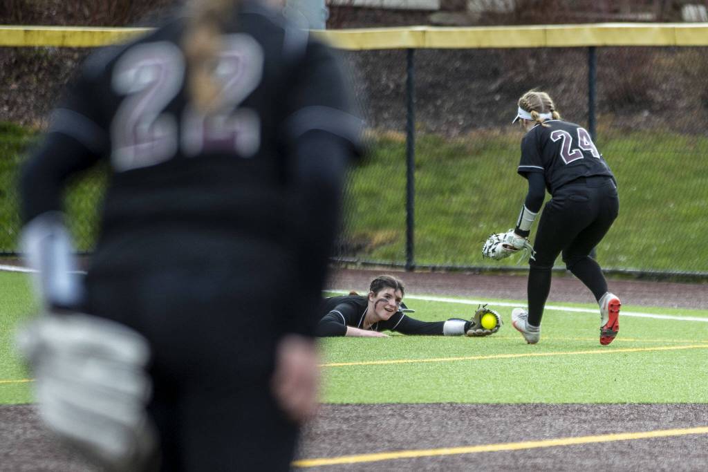 Cascade players celebrate a catch in the outfield during an Everett and Cascade softball game at Phil Johnson Ballfields in Everett, Washington on Friday, April 21, 2023. Cascade won, 12-2. (Annie Barker / The Herald)
