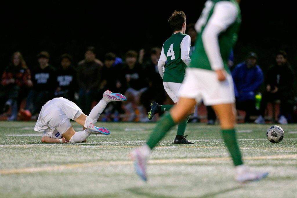 Shorewoods Dzanan Fikic takes a hard tumble and loses the ball against Edmonds-Woodway on Friday, April 21, 2023, at Edmonds Stadium in Edmonds, Washington. (Ryan Berry / The Herald)
