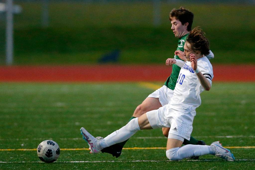 Shorewoods Dzanan Fikic tackles the ball away from the opponent against Edmonds-Woodway on Friday, April 21, 2023, at Edmonds Stadium in Edmonds, Washington. (Ryan Berry / The Herald)
