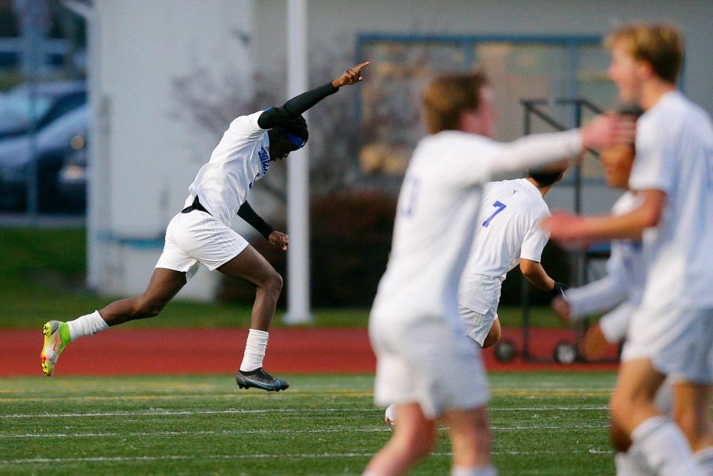 Shorewood senior attacker Anthony Henry and teammates begin to celebrate his first half goal against Edmonds-Woodway on Friday, April 21, 2023, at Edmonds Stadium in Edmonds, Washington. (Ryan Berry / The Herald)
