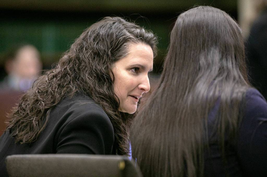 Martha Saracino turns to speak with fellow members of the prosecution during the first day of the trial of Shayne Baker on Monday, April 24, 2023, at Snohomish County Superior Court in Everett, Washington. (Ryan Berry / The Herald)