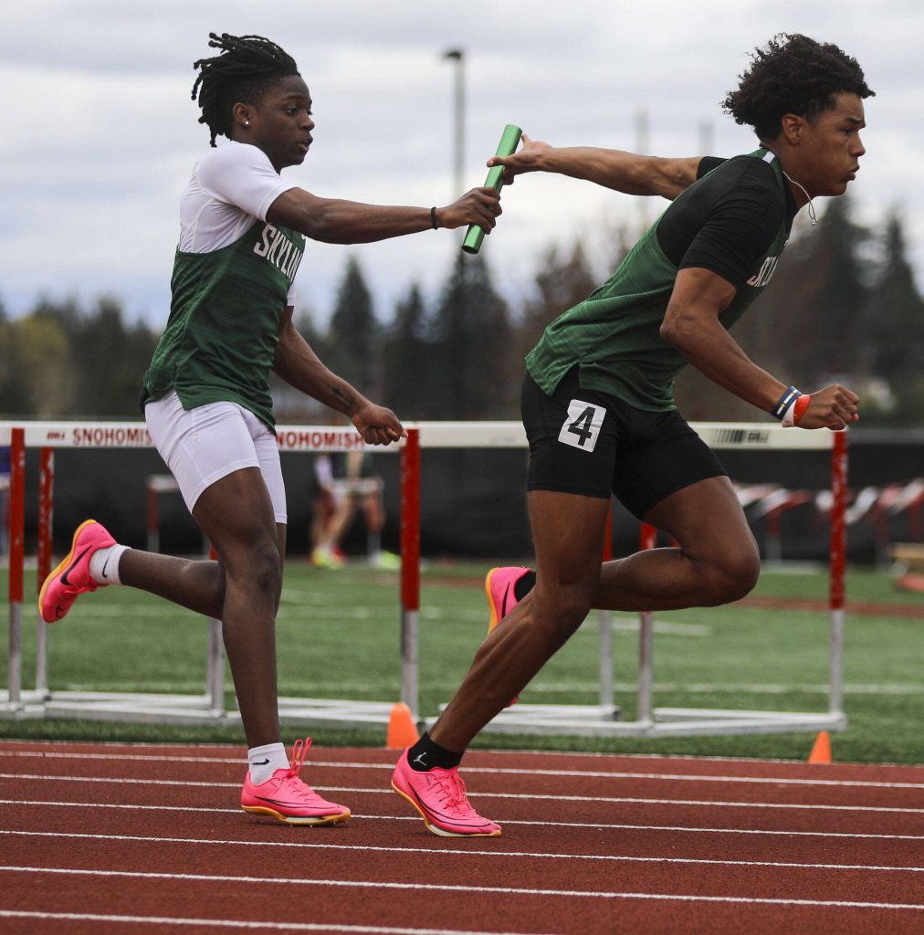 Skyline athletes pass off a baton during the boys 4x100 relay during the Eason Invitational at Veterans Memorial Stadium in Snohomish, Washington on Saturday, April 22, 2023. (Annie Barker / The Herald)