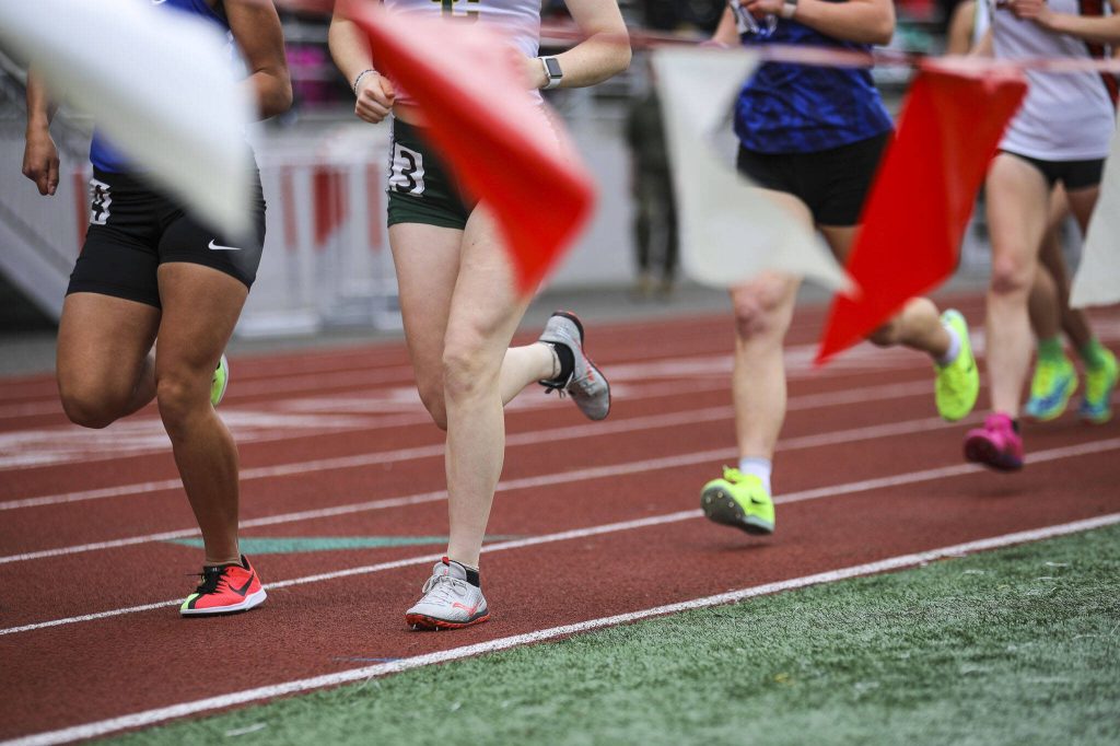 Runners race during the Eason Invitational at Veterans Memorial Stadium in Snohomish, Washington on Saturday, April 22, 2023. (Annie Barker / The Herald)
