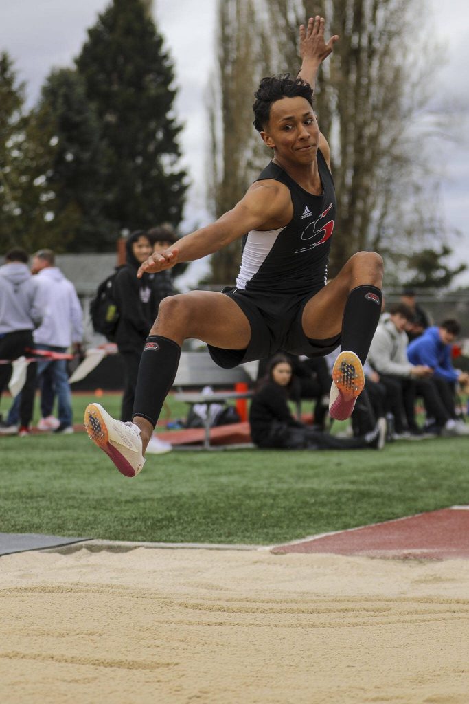 An athlete performs the triple jump during the Eason Invitational at Veterans Memorial Stadium in Snohomish, Washington on Saturday, April 22, 2023. (Annie Barker / The Herald)