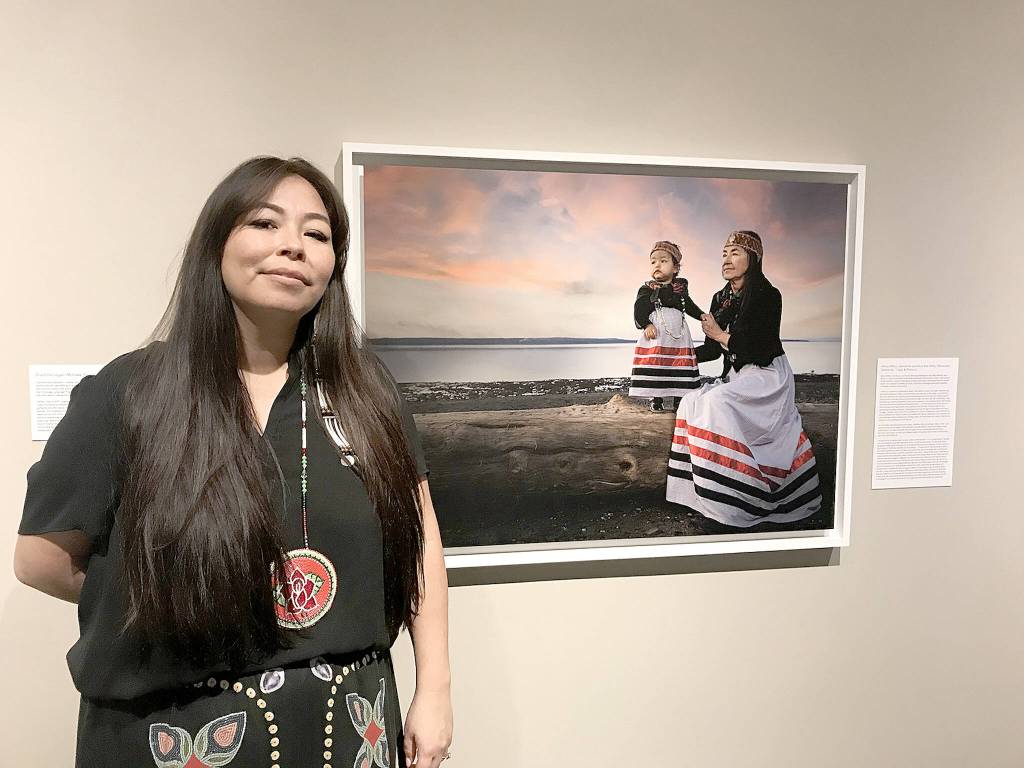 Photographer Matika Wilbur from the Tulalip and Swinomish tribes with a piece from her exhibition Seeds of Culture: Portraits and Stories of Native Women which was displayed at the Whatcom Museum in Bellingham, Washington. (Gale Fiege / The Herald file)