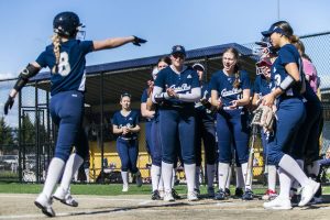 Glacier Peak’s Faith Jordan celebrates her homer with her teammates during the game against Lake Stevens on Tuesday, April 25, 2023 in Lake Stevens, Washington. (Olivia Vanni / The Herald)