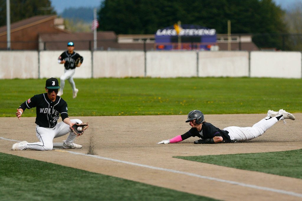 Lake Stevens Aspen Alexander slides in safe at third after avoiding the tag in a win over Jackson on Wednesday, April 26, 2023, in Lake Stevens, Washington. (Ryan Berry / The Herald)