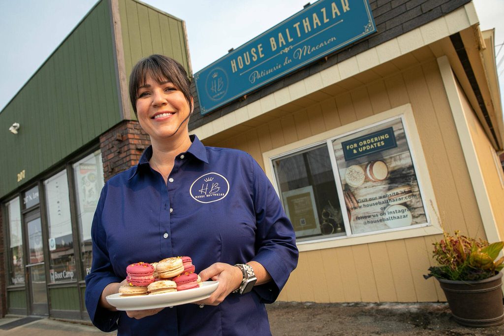 Lisa Laidlaw stands outside of the tiny storefront of House Balthazar, her new macaron patisserie, on Monday, Oct. 17, 2022, in Monroe, Washington. (Ryan Berry / The Herald)