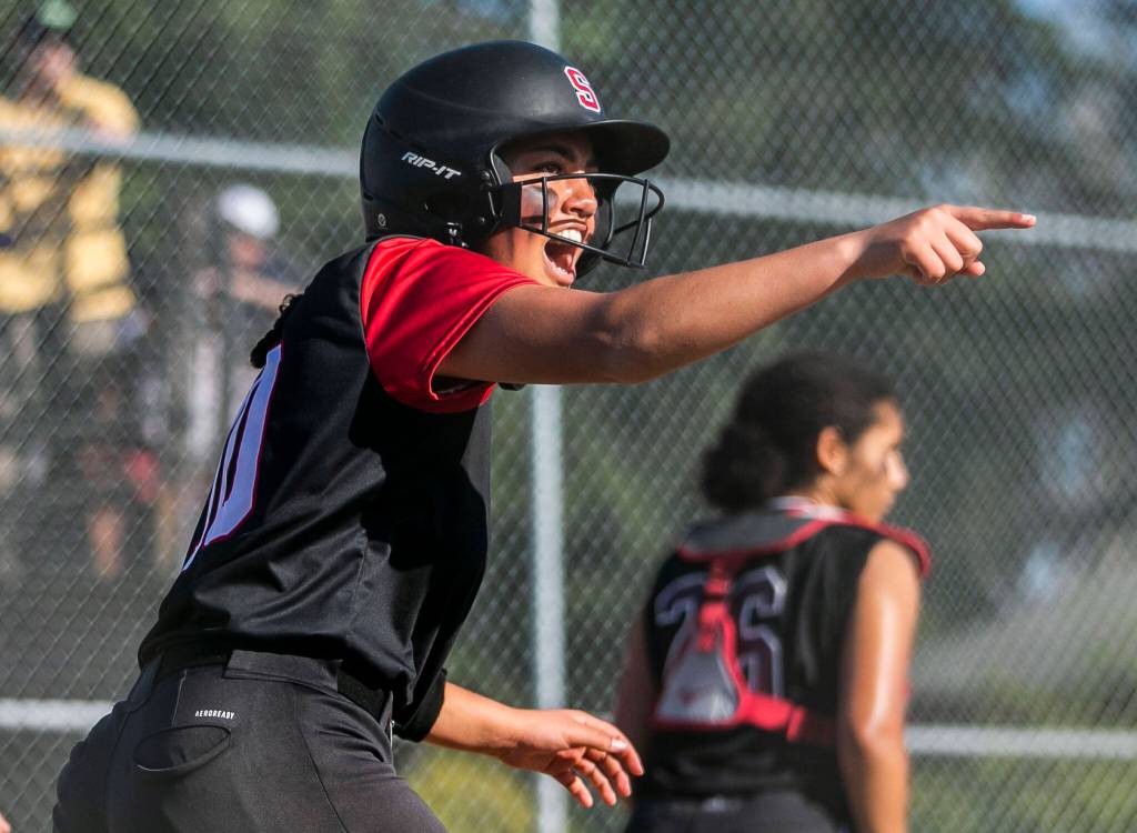 Snohomishs Emma Hansen cheers on her teammate after getting a hit to score her during the game against Cascade on Friday, April 28, 2023 in Snohomish, Washington. (Olivia Vanni / The Herald)