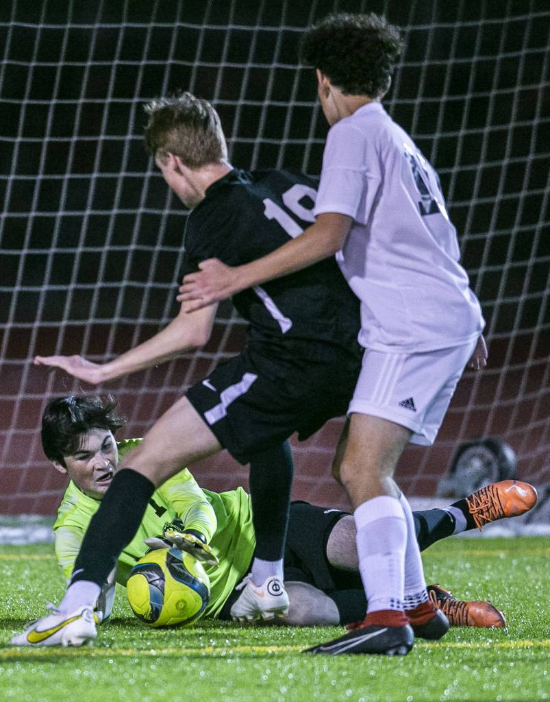 Jackson goalie Ben Ferguson blocks a shot during the game against Glacier Peak on Friday, April 28, 2023 in Snohomish, Washington. (Olivia Vanni / The Herald)