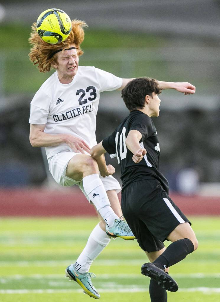 Glaicer Peaks Kollin Undseth beats Jacksons Archilea Dhima to the ball for a header during the game on Friday, April 28, 2023 in Snohomish, Washington. (Olivia Vanni / The Herald)