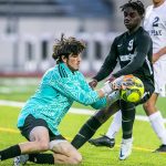 Jackson’s Jaden Oguda challenges Glacier Peak’s goalie Austin Riechelson for the ball after a shot during the game on Friday, April 28, 2023 in Snohomish, Washington. (Olivia Vanni / The Herald)