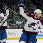 Colorado Avalanche center Nathan MacKinnon (29) and left wing Artturi Lehkonen celebrate a goal by Erik Johnson against the Seattle Kraken during the second period of Game 6 of an NHL hockey Stanley Cup first-round playoff series Friday, April 28, 2023, in Seattle. (AP Photo/Lindsey Wasson)