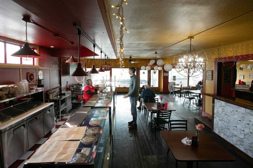 A customer chats with an employee before heading out at Pisces Pies on Thursday, April 13, 2023, in north Everett, Washington. (Ryan Berry / The Herald)
A customer chats with an employee before heading out at Pisces Pies on Thursday, April 13, 2023, in north Everett, Washington. (Ryan Berry / The Herald)