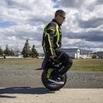 Eric Rowe, 48, demonstrates sitting on an electric unicycle at the Everett Marina in Everett, Washington on Sunday, May 7, 2023. (Annie Barker / The Herald)