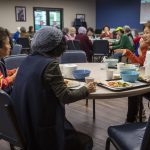 Seung Lee, right, talks to tablemates during a senior community meals program focused on the Korean community at Homage in Lynnwood, Washington on Thursday, May 4, 2023. (Annie Barker / The Herald)