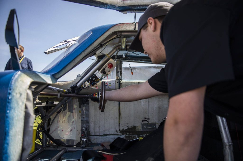 Andrew Dee talks about the adjustments made to the steering wheel on the teams urban concept diesel car on Thursday, April 27, 2023 in Granite Falls, Washington. (Olivia Vanni / The Herald)