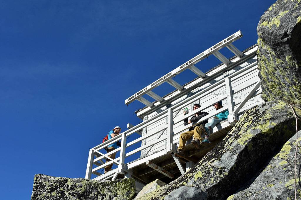 Hikers enjoy the catwalk around the Mount Pilchuck fire lookout in early November 2019. (Caleb Hutton / The Herald)