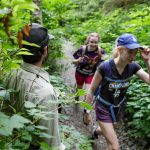 Forest ranger Justin Sundstrom steps off the trail heading to Heather Lake for hikers Saturday morning near Granite Falls, Washington on July 23, 2022. (Kevin Clark / The Herald)