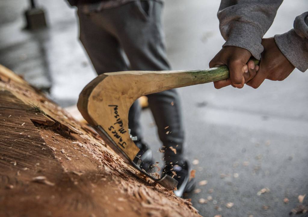 Archbishop Murphy students use a lip adze tool on Friday, May 5, 2023 in Everett, Washington. (Olivia Vanni / The Herald)