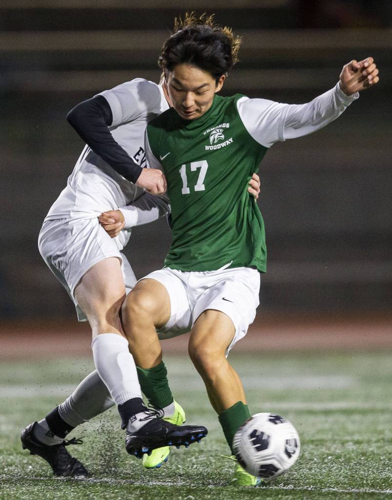 Edmonds-Woodways Christopher Hur is grabbed while flighting for the ball during the game against Everett on Monday, May 1, 2023 in Edmonds, Washington. (Olivia Vanni / The Herald)