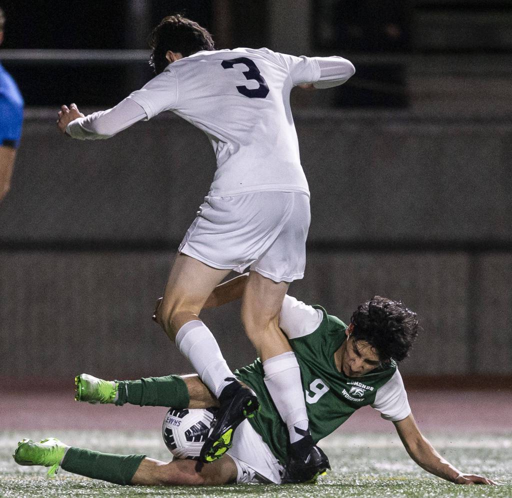 Everetts Stephen Post is slide tackled by Edmonds-Woodways Isaac Parreno during the game on Monday, May 1, 2023 in Edmonds, Washington. (Olivia Vanni / The Herald)