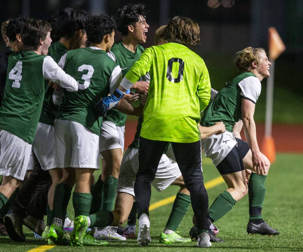 Edmonds-Woodways Kincaid Sunds game winning goal is celebrated by his teammates on Monday, May 1, 2023 in Edmonds, Washington. (Olivia Vanni / The Herald)