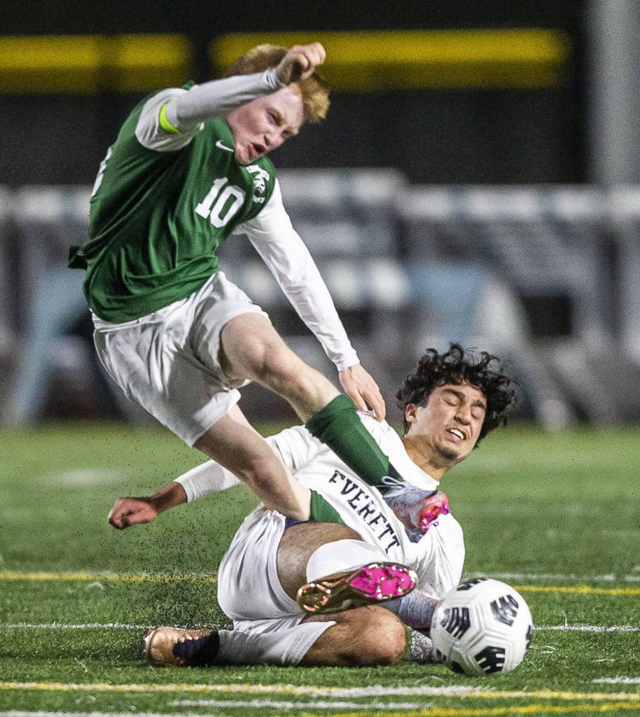 Everetts Nussrat Nussrat slide tackles Edmonds-Woodways Ben Hanson during the game on Monday, May 1, 2023 in Edmonds, Washington. (Olivia Vanni / The Herald)