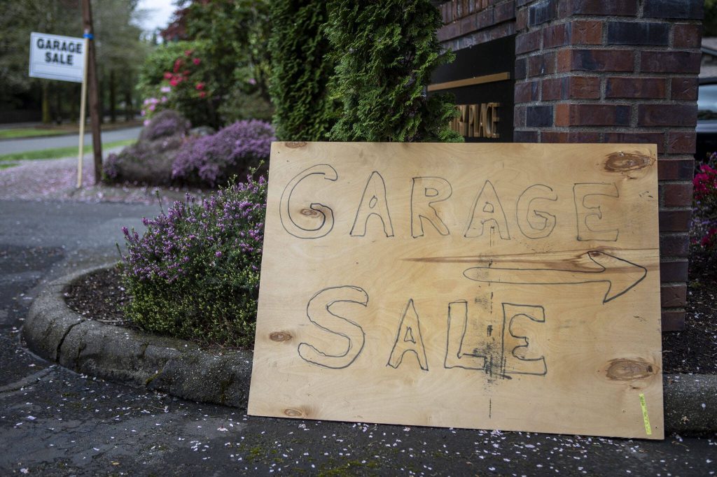 A sign for a garage sale in Mill Creek, Washington on Saturday, May 6, 2023. (Annie Barker / The Herald)
