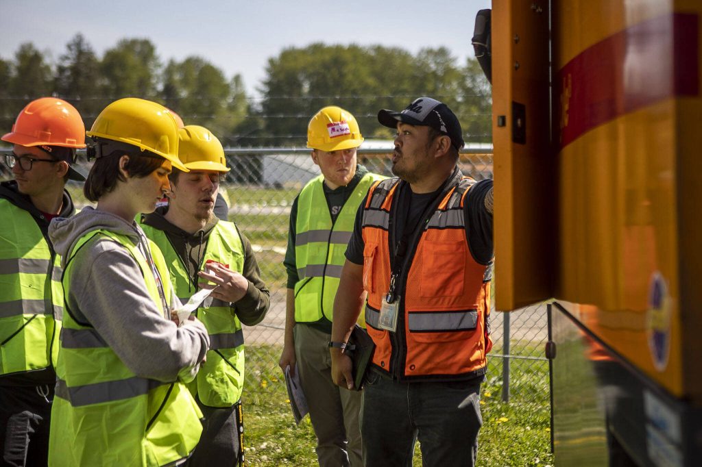 Brandon Ohashi talks about streetcleaners during a trade fair at the Evergreen State Fairgrounds in Monroe, Washington on Wednesday, May 3, 2023. High school kids learned about various trades at the event. (Annie Barker / The Herald)