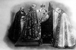 The Archbishop of Canterbury places the crown on King George V during his coronation ceremony at Westminster Abbey in London, England, June 22, 1911.  At left is the dean of Westminster, and at right is the Bishop of Bath and Wells.  (AP Photo)