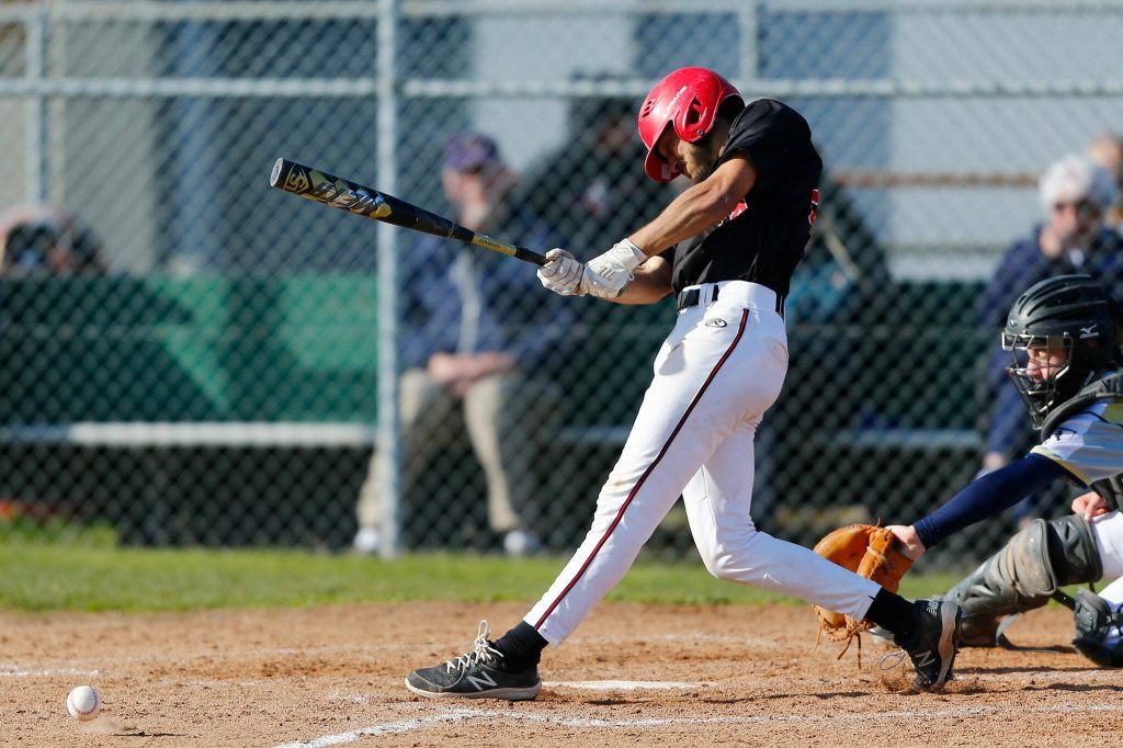 Snohomish’s Nickolas Sakamoto rips a multi-bagger down the line during a game against Arlington on Friday, April 14, 2023, at Earl Torgeson Field in Snohomish, Washington. Sackamoto scored on the play after a handful of misplays by the defense. (Ryan Berry / The Herald)