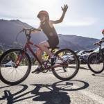 Blake Miller, left and Trentyn Greening, right, stick their arms out to signal their left turn during a bike safety class at Darrington Elementary School on Friday, May 12, 2023 in Darrington, Washington. (Olivia Vanni / The Herald)
