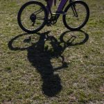 A students shadow is cast on the ground as they ride their bike during a bike safety class at Darrington Elementary School on Friday, May 12, 2023 in Darrington, Washington. (Olivia Vanni / The Herald)
