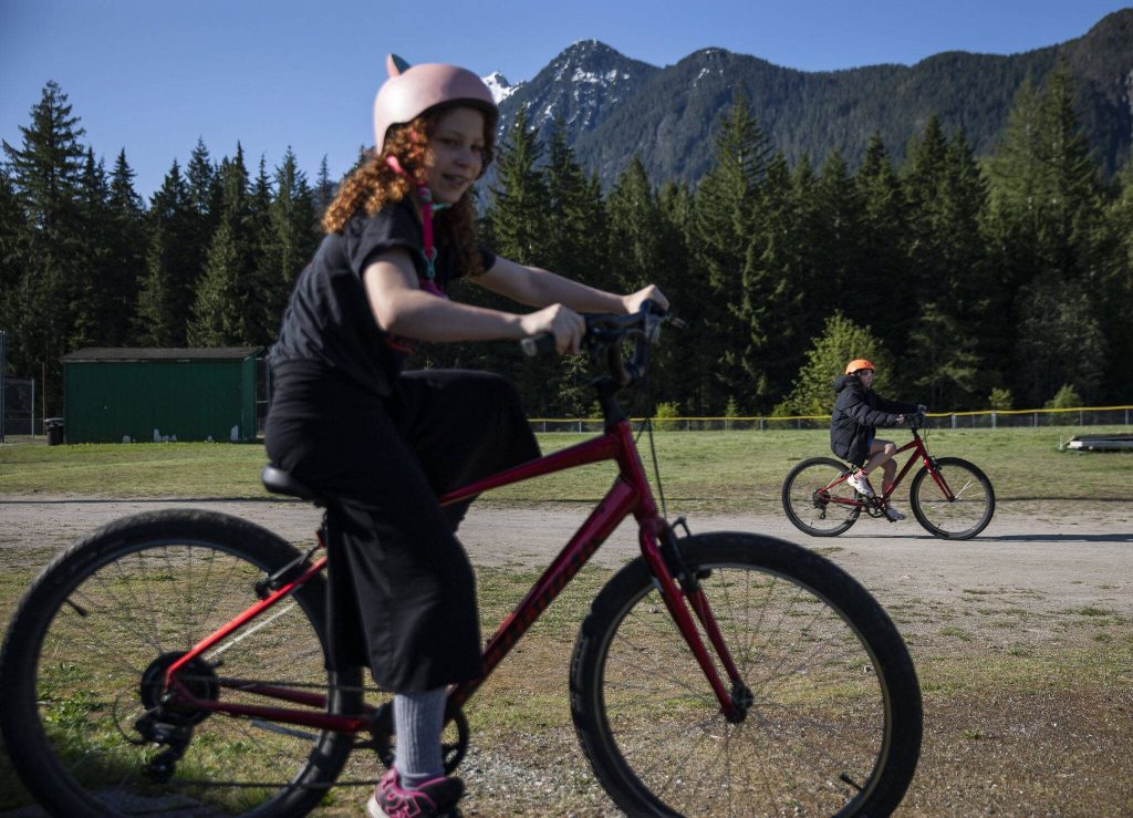 Students ride around on their bikes before the start of bike safety class at Darrington Elementary School on Friday, May 12, 2023 in Darrington, Washington. (Olivia Vanni / The Herald)