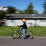 A student rides down a road during a bike safety exercise at Darrington Elementary School on Friday, May 12, 2023 in Darrington, Washington. (Olivia Vanni / The Herald)